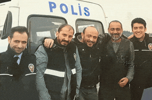 Photo gif. A picture of a group of policemen from a different country is animated with a shine that goes through the picture.