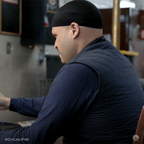 TV gif. Joe Minoso as Joe Cruz in Chicago Fire, seated, turns around with a WTF? look on his face.
