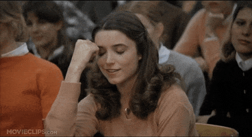 Movie gif. Karen Allen as Katy in Animal House. She has her arm on a table and her head is in her hand as she laughs softly and closes her eyes in dismay.
