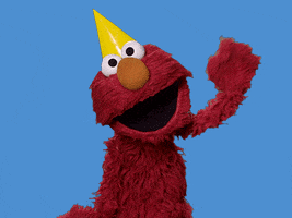 Sesame Street gif. Wearing a yellow party hat, Elmo cheerfully waves at us.