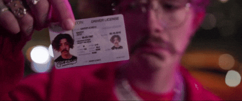 man showing a bad driver's license photo