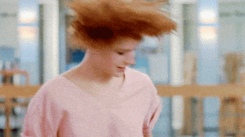 Movie gif. Molly Ringwald as Claire in "The Breakfast Club," intensely bopping and dancing, swinging her arms left and right.