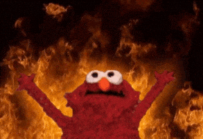 Digital art gif. Red Elmo yells with arms raised and wide eyes as animated roaring flames burn behind him.