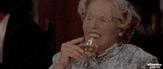 Movie gif. Robin Williams as Mrs. Doubtfire takes a sip of her drink, losing her veneers, and they plop into the glass.
