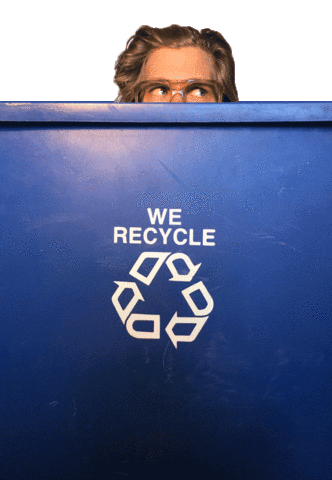 Digital art gif. Pair of blue eyes with thick-framed glasses peek out from behind a large recycling bin that says, "We recycle" with a white recycling symbol below.