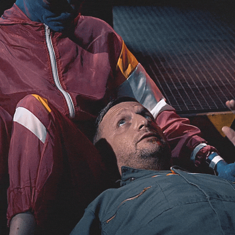Movie or TV gif. Tim Robinson lays on the floor in mechanic coveralls next to a person dressed as an alien in a red tracksuit. Tim Robinson says, "Good night probably forever," then closes his eyes as the alien waves at him. 