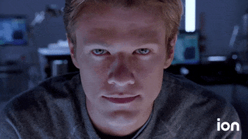 TV gif. Lucas Till as MacGyver in a closeup looks at us and nods, smiling or smirking slightly and raising his eyebrows. 