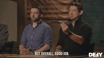 Reality TV gif. Sitting as judge next to Ben Abbott, Doug Marcaida on Forged in Fire holds up a dagger and examines it, then smiles and says, "but overall, good job," which appears as text.