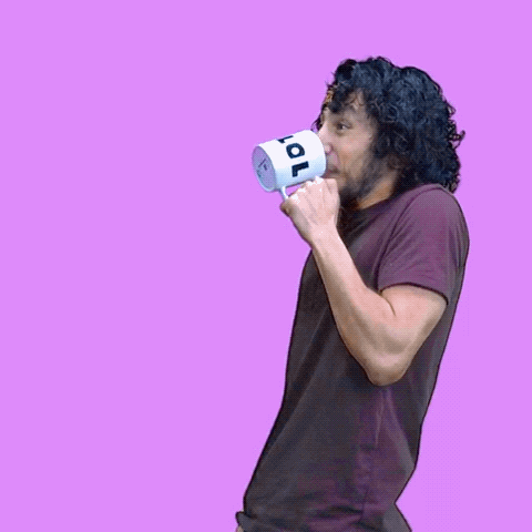 Video gif. Man does a spit take in front of a lilac background. He drinks from a mug, then heaves forward as cartoon liquid spews from his mouth, morphing into text that reads, "LOL."
