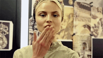 Celebrity gif. Magdalena Frąckowiak, a Polish designer and model, blows us a kiss and sends us a wink.