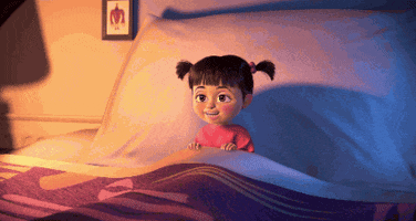 Movie gif. Boo from Monsters Inc sits up in bed, taking in short quick breaths before she crashes to the side and falls immediately to sleep. 