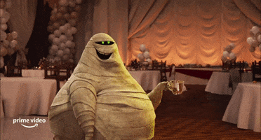 Cartoon gif. Murray the Mummy from Hotel Transylvania gets hit by a green laser as he holds a teacup. He looks shocked as the laser goes through him but only ruffles his band aids.