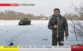 Video gif. News reporter is standing in front of a frozen lake with a car on top. As he's speaking, the car breaks through the ice and falls through. The reporter is aghast and drops his hand holding the microphone down to his side, stunned.