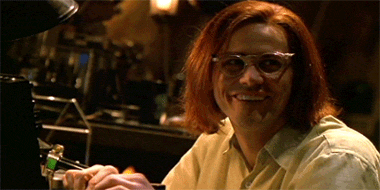 Movie gif. Jim Carrey as The Riddler in Batman Forever. He stares at someone with a dopey smile before cocking his head and lurching towards them in his chair saying, "THANK YOU! Thank you so much!" He then turns back to his typewriter and begins pounding away, riveted by his new thought. 