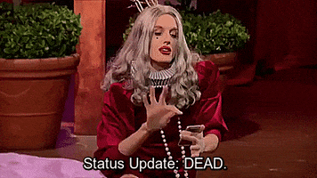 TV gif. A person with long curly hair dressed in Shakespearean-era clothes on RuPaul's Drag Race pointedly taps a phone and says, "Status update: Dead," which appears as text.