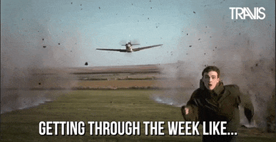 Video gif. A man runs away in terror from a fighter plane in the sky that’s shooting at him. The ground smokes as bullets hit the ground in a straight line. Text, “Getting through the week like…”