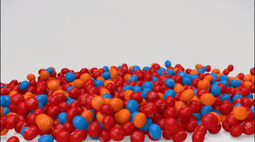 Ad gif. A pile of different colored M and M’s all form to make a heart. An arrow made out of M and Ms shoots through the heart. Caramel drips off the top of the arrow. Text, “I  heart you.”