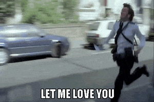 Celebrity gif. David Tennant sprints down the street in his suit with suspenders, chasing down a vehicle. Text at the bottom reads, "Let me love you."