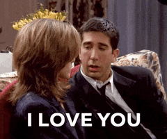 Friends gif. Wearing a black suit jacket and seated on a flower-patterned couch, David Schwimmer as Ross Geller drunkenly tries to woo the woman sitting next to him. Text, "I love you the most!"