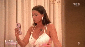 Video gif. An angry actress throws her phone.