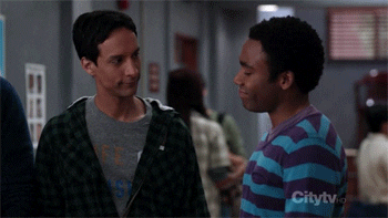 TV gif. Danny Pudi as Abed and Donald Glover as Troy in "Community" do a handshake, slapping each other's hands and their own chests at the same time.