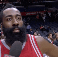Sports gif. James Harden wears his Clippers jersey and rolls his eyes at a person holding a microphone before he turns to walk away.