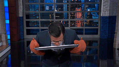 Stephen Colbert sniffing a baking sheet of cookies