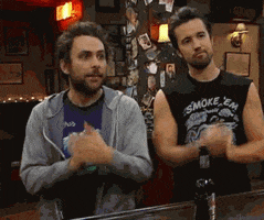 TV gif. Charlie Day as Charlie and Rob McElhenney as Mac in It's Always Sunny in Philadelphia stand at a bar and stomp and clap their hands in unison.