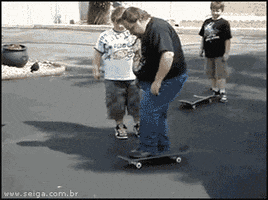 Video gif. A heavyset man steps onto a skateboard in a street among onlookers. He rolls down the street past a palm tree but loses his footing, dramatically falling backwards off the skateboard several feet and into a nearby parked car before collapsing to the ground.
