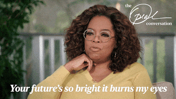 TV gif. Oprah Winfrey rests a hand under her chin like she's studying someone. Text, "Your future's so bright it burns my eyes."