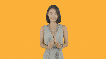 TV gif. Elsha Kim as Yunjin Garcia of The Garcias places her palms together in front of her chest and bows in a "namaste" gesture.