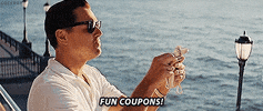 Movie gif. Leonardo DiCaprio as Jordan Belfort in Wolf of Wall Street stands over a pier flicking dollar bills down while saying, "Fun coupons!" which appears as text.