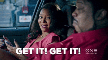 Movie gif. A scene from Deadly Dispatch. In the front seat of a car, a cheerful Tamala Jones as Tiffany and Bone Crusher as Shawn dance with their shoulders. Text, "Get it! Get it!"