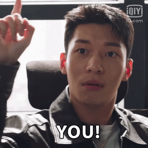 TV gif. Wi Ha-joon as K from Bad and Crazy sits in an office chair, pleasantly surprised as he points at us. Text, "You!"