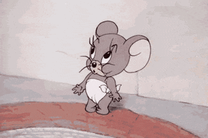 Cartoon gif. Nibbles from Tom and Jerry wears a diaper and points to his mouth, smacking his lips and then rubbing his belly.