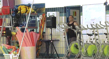 Video gif. Man enters the room to look in an empty indoor swimming pool that has a red stuffed fish flopping around in it. The man stands there with his hands on his hips, confused. He then turns around and leaves.
