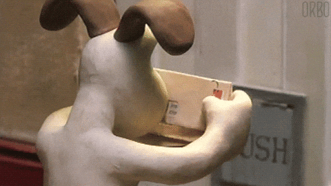 a cartoon dog is holding a box in its paws .