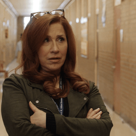 TV gif. Lisa Ann Walter as Melissa in Abbott Elementary. Her hands are crossed and she looks at something incredulously before turning to the camera.