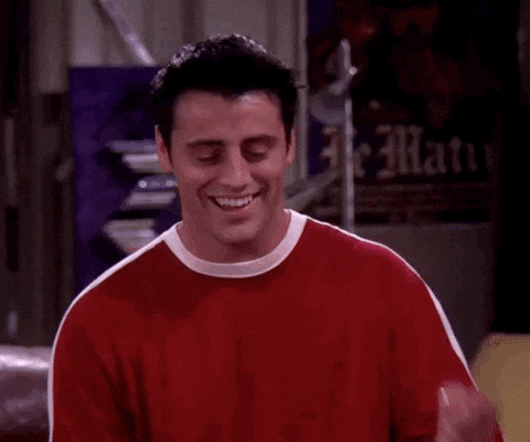 a man is wearing a red sweater and smiling .