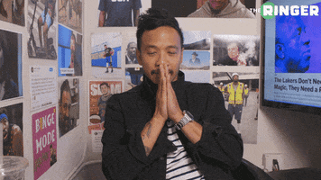 Video gif. Jason Concepcion holds his hands to his mouth in prayer, before glancing to the side and bursting with excitement as he grips his chair.