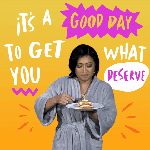 Video gif. A woman in a robe holds a plate of pancakes and takes a slow, satisfying bite. She does a little dance of happiness. Text, "It's a good day to get what you deserve."