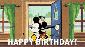 Disney gif. Mickey Mouse enters a festively decorated room full of his friends who are celebrating wildly. Text, “Happy Birthday!”