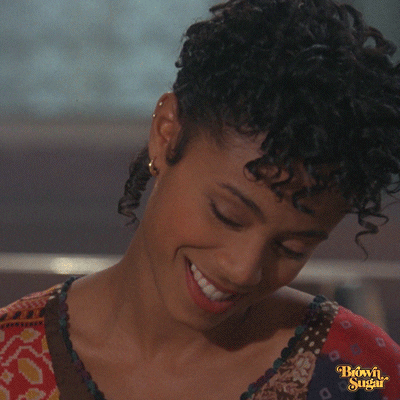 Movie gif. Jada Pinkett Smith as Lyric in Jason's Lyric. She leans to the side and smiles at the ground before biting her lip and leaning forward, staring at her date deeply as she begins to fall in love.