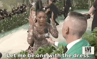 Met Gala 2024 gif. Keke Palmer, speaking to a reporter, amplifies her words with wavy hand gestures, saying, "Let me be the one with the dress."