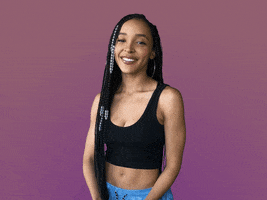 Celebrity gif. Tinashe looks touched as she puts her hands out towards us and says, "Thank you."