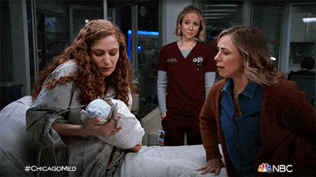 TV gif. Scene from Chicago Med. In a hospital room, a woman with tears soaking her cheeks hands over a baby to another woman. The other woman moves closer and takes the baby in her arms. A nurse in the background looks on with a bittersweet smile.