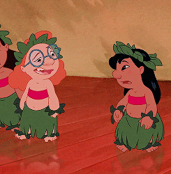 Disney gif. In the middle of hula practice, Lilo from Lilo and Stitch pounces on her nemesis Mertle Edmonds and punches her in the nose.