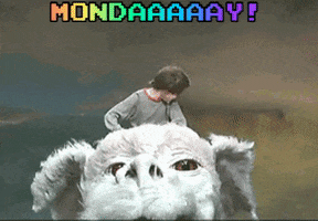 Movie gif. Noah Hathaway as Atreyu in The Neverending Story. Atreyu rides Falcor through the skies and the wind billows through both of their hair. Atreyu is whooping and hollering and raises a fist in freedom and motivation. Text, "Mondaaaaaay!"