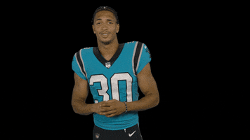 Sports gif. Chuba Hubbard of the Carolina Panthers gives us a skeptical smile with his hands out like, "Really?"