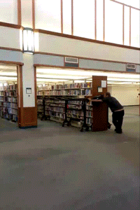 Gif where someone is moving a big part of a physical library to some other place as a metaphor